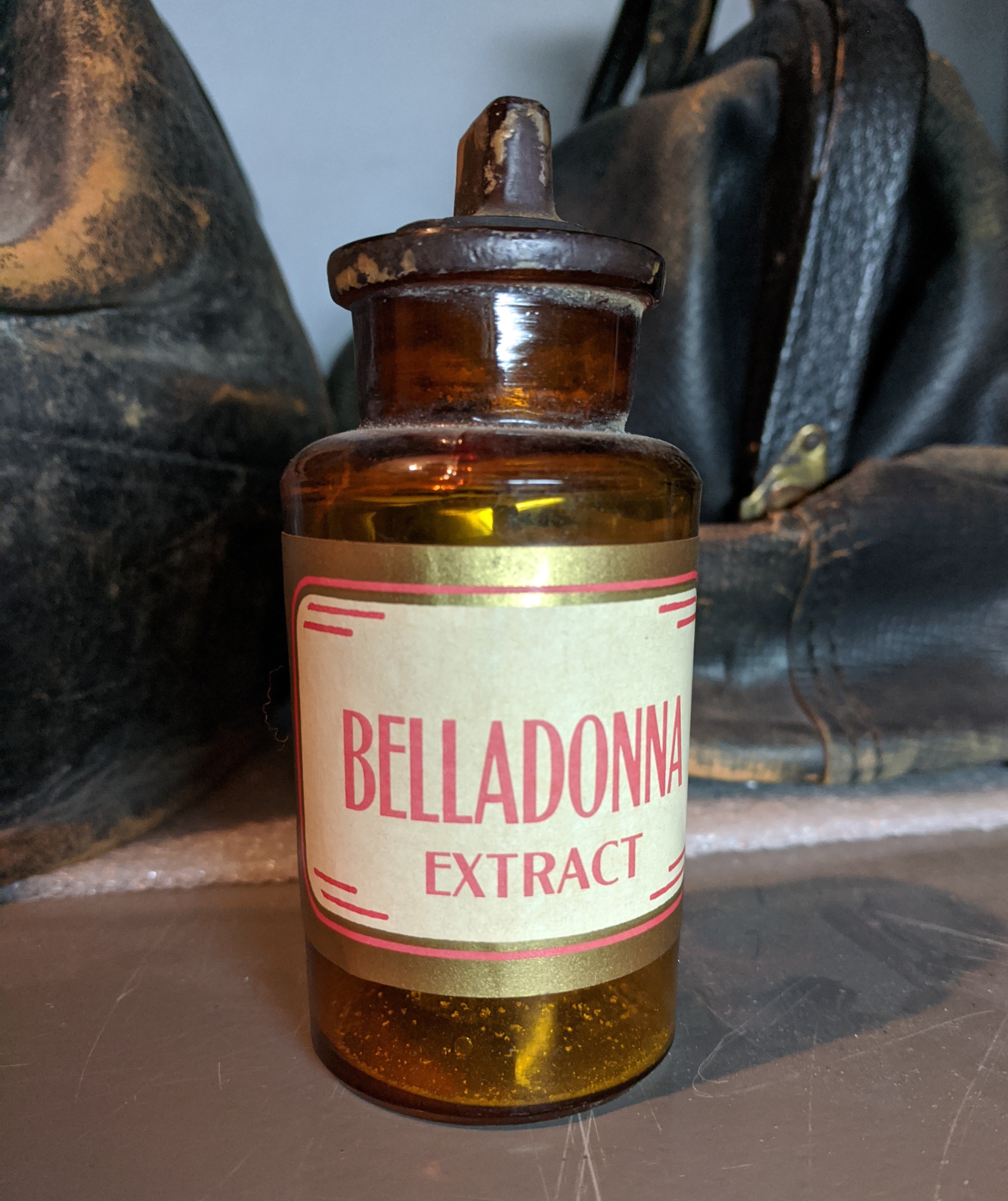 A bottle of Belladonna extract on a shelf.