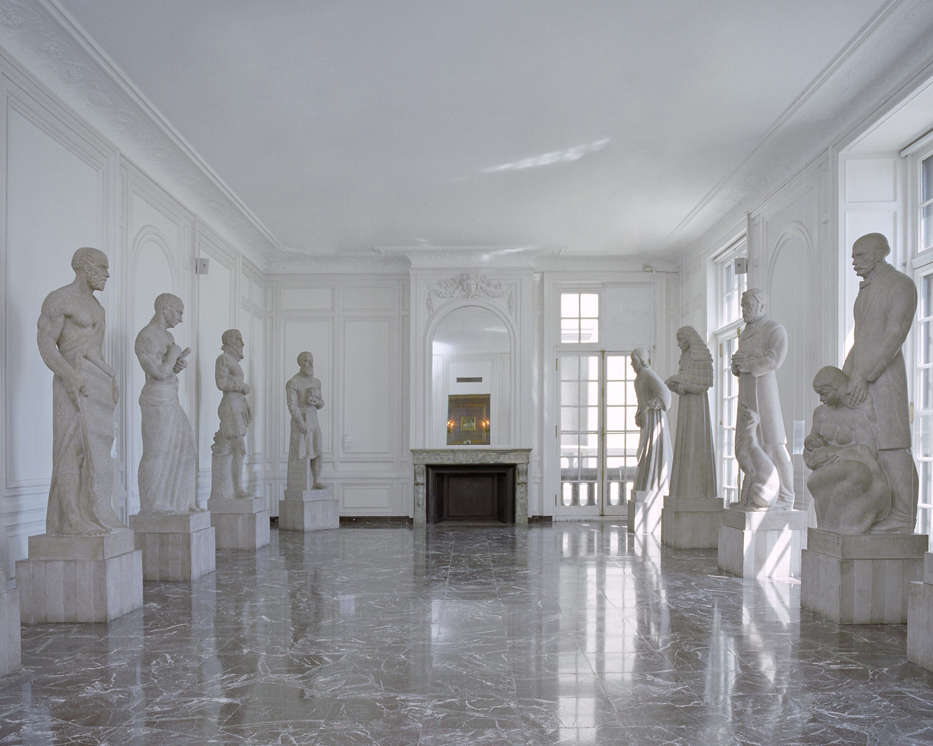 Color photo of the Hall of Immortals. Seven stone sculptures can be seen of different people from medical history.